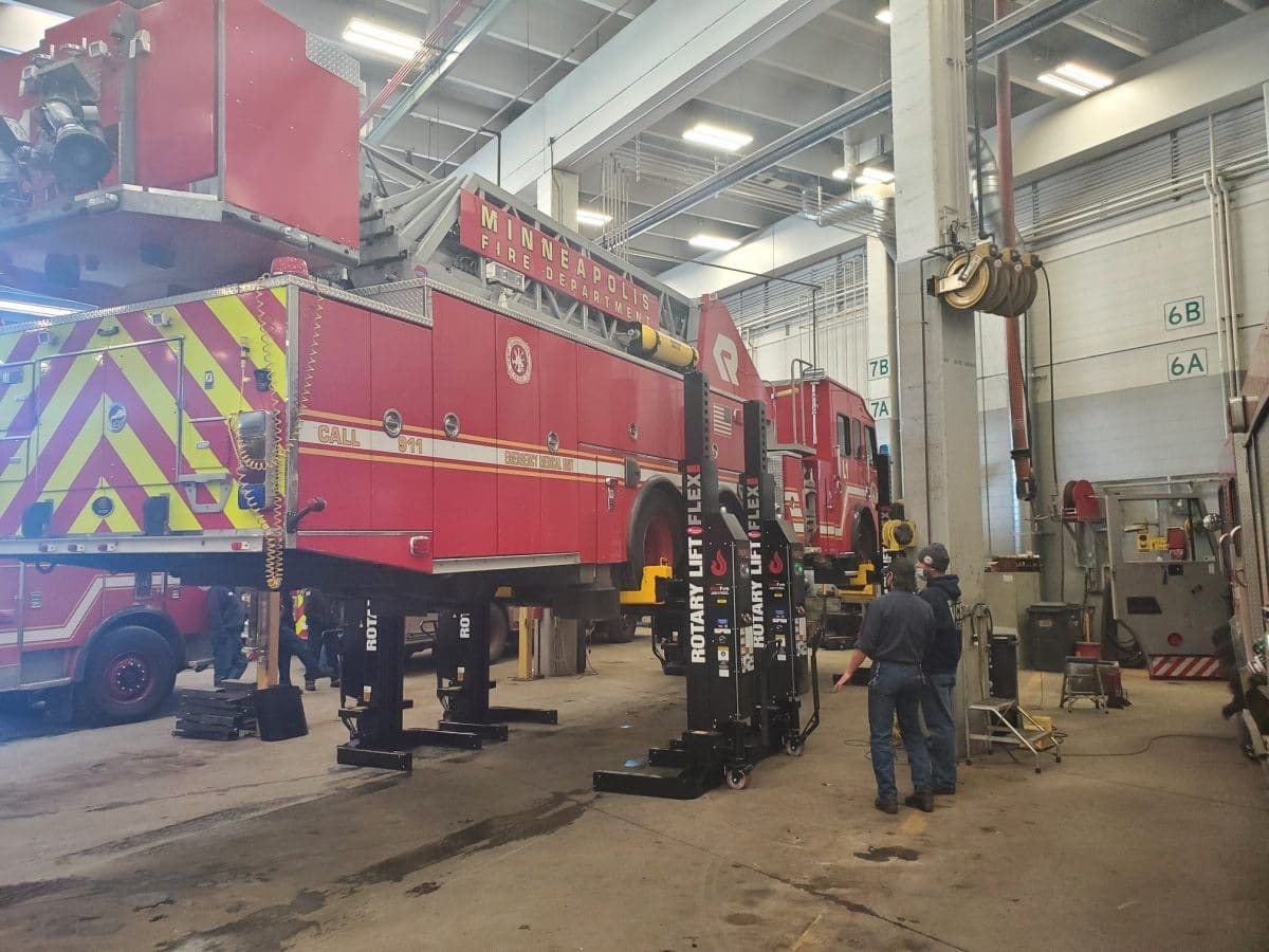 Minneapolis firetruck being hoisted by a rotary lift